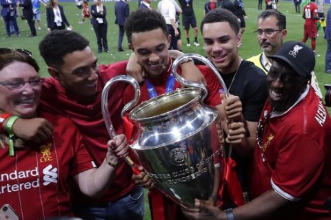 Liverpool's Trent Alexander-Arnold poses with the trophy after winning the Champions League final soccer match between Tottenham Hotspur and Liverpool at the Wanda Metropolitano Stadium in Madrid, Saturday, June 1, 2019. (AP Photo/Manu Fernandez)