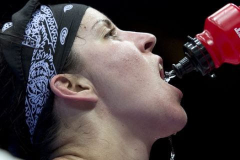 Canada's Mary Spencer drinks some water after losing 17-14 against China's Jinzi Li during their 68-75kg women's quarterfinal bout at the 2012 Summer Olympics Monday, August 6, 2012 in London.(AP Photo/The Canadian Press, Ryan Remiorz)