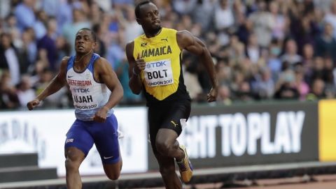 Jamaica's Usain Bolt, right, and Britain's Chijindu Ujah compete in a Men's 100 meters semifinal during the World Athletics Championships in London Saturday, Aug. 5, 2017. (AP Photo/Tim Ireland)