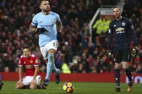Manchester City's Nicolas Otamendi, center, celebrates after scoring his side's second goal during the English Premier League soccer match between Manchester United and Manchester City at Old Trafford Stadium in Manchester, England, Sunday, Dec. 10, 2017. (AP Photo/Dave Thompson)