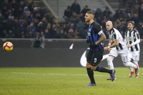 Inter Milan's Mauro Icardi scores his team's first goal on a penalty kick during an Italian Serie A soccer match between Inter Milan and Udinese, at the San Siro stadium in Milan, Italy, Saturday, Dec. 15, 2018. (AP Photo/Antonio Calanni)
