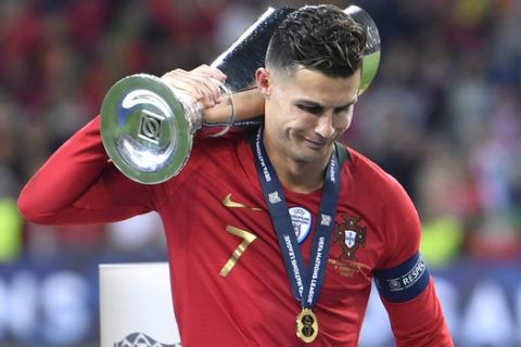 Portugal's Cristiano Ronaldo holds the trophy as he celebrates winning the UEFA Nations League final soccer match between Portugal and Netherlands at the Dragao stadium in Porto, Portugal, Sunday, June 9, 2019. Portugal won 1-0. (AP Photo/Martin Meissner)