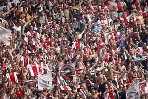 Ajax Amsterdam's soccer fans celebrate during the Dutch soccer League match between Ajax and FC Twente at the Arena stadium in Amsterdam, The Netherlands, Sunday May 15, 2011. Ajax won the last match of the season against FC Twente, 2-0. (AP Photo/Bas Czerwinski)