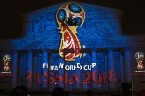 The official logo for the 2018 FIFA World Cup is presented on the facade of the Bolshoi Theatre in Moscow, Russia, Wednesday, Oct. 29, 2014. FIFA President Sepp Blatter has revealed the logo for the 2018 World Cup in Russia - with the help of a crew of cosmonauts. The logo depicts the World Cup trophy in red and blue, colors from the Russian flag, with gold trim. (AP Photo/Pavel Golovkin) 