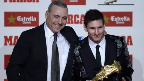 Former soccer player Hristo Stoichkov from Bulgaria, left, poses for the media with Barcelona's Lionel Messi from Argentina after receiving the Golden Boot award for scoring the most goals in Europe's domestic leagues last season in Barcelona, Spain, Wednesday, Nov. 20, 2013. (AP Photo/Manu Fernandez)