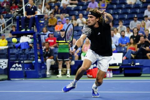 Stefanos Tsitsipas, of Greece, returns a shot to Milos Raonic, of Canada, during the first round of the U.S. Open tennis championships, Monday, Aug. 28, 2023, in New York. (AP Photo/Frank Franklin II)