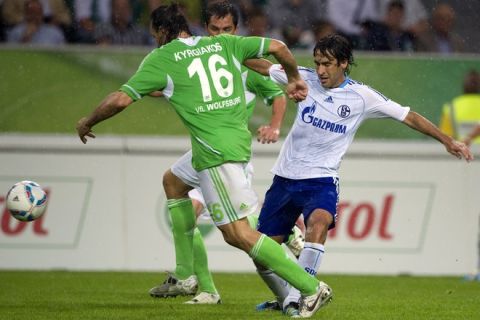 Schalke's Spanish striker Raul (R) and Wolfsburg's Greek defender Sotirios Kyrgiakos (L) vie for the ball during the German first division Bundesliga football match between Wolfsburg and Schalke 04 in the central German city of Wolfsburg on 11 September, 2011. AFP PHOTO / ODD ANDERSEN

RESTRICTIONS / EMBARGO - DFL LIMITS THE USE OF IMAGES ON THE INTERNET TO 15 PICTURES (NO VIDEO-LIKE SEQUENCES) DURING THE MATCH AND PROHIBITS MOBILE (MMS) USE DURING AND FOR FURTHER TWO HOURS AFTER THE MATCH. FOR MORE INFORMATION CONTACT DFL. (Photo credit should read ODD ANDERSEN/AFP/Getty Images)