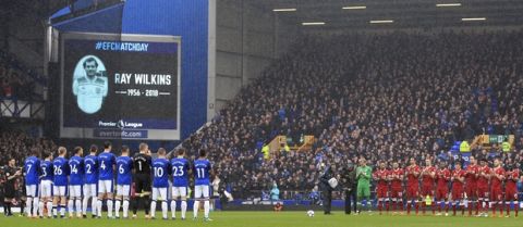 Everton and Liverpool players hold a minute's silence in memory of the late Ray Wilkins before the Premier League soccer match between Everton and Liverpool at Goodison Park, Liverpool England. Saturday, April 7, 2018. (Peter Byrne/PA via AP)