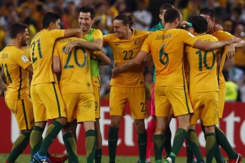 Australian players celebrate after defeating Honduras during their World Cup soccer playoff deciding match in Sydney, Australia, Wednesday, Nov. 15, 2017. (AP Photo/Daniel Munoz)