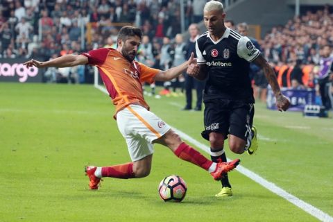 In this  Saturday, Sept. 24, 2016 photo, Galatasaray's Sabri Sarioglu, left, and Ricardo Quaresma of Besiktas fight for the ball during their Turkish League soccer derby match at the Vodafone Arena Stadium in Istanbul, Turkey. (AP Photo)