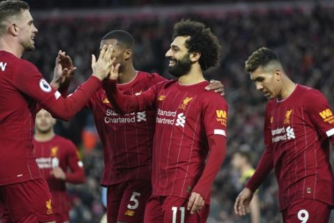 Liverpool's Mohamed Salah, 2nd right, celebrates with teammates after scoring his sides third goal during the English Premier League soccer match between Liverpool and Southampton at Anfield Stadium, Liverpool, England, Saturday, February 1, 2020. (AP Photo/Jon Super)