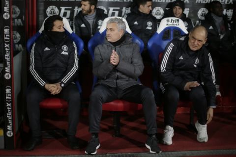 Manchester United manager Jose Mourinho, centre, looks across the pitch before the English Premier League soccer match between Crystal Palace and Manchester United at Selhurst Park in London, Monday, March 5, 2018. (AP Photo/Tim Ireland)