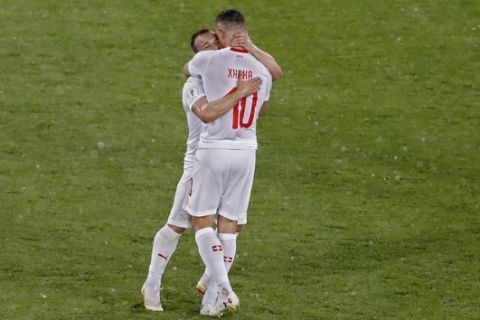 Switzerland's Xherdan Shaqiri and Granit Xhaka, right, celebrate at the end of the group E match between Switzerland and Serbia at the 2018 soccer World Cup in the Kaliningrad Stadium in Kaliningrad, Russia, Friday, June 22, 2018. Shaqiri and Xhaka scored once each in Switzerland's 2-1 victory. (AP Photo/Antonio Calanni)