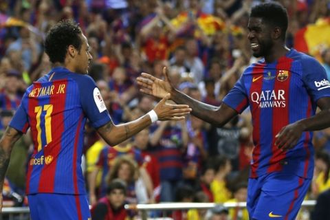 Barcelona's Neymar, left, celebrates with Barcelona's Samuel Umtiti after scoring a goal during the Copa del Rey final soccer match between Barcelona and Alaves at the Vicente Calderon stadium in Madrid, Spain, Saturday May 27, 2017. (AP Photo/Daniel Ochoa de Olza)