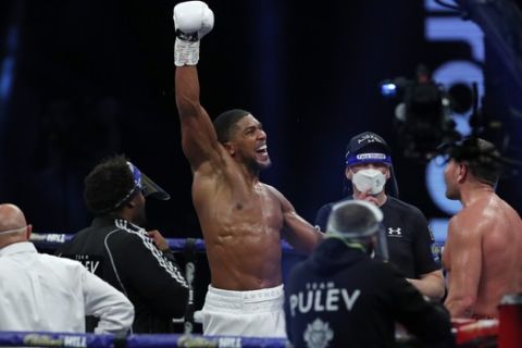 World Heavyweight boxing champion Britain's Anthony Joshua celebrates after beating challenger Bulgaria's Kubrat Pulev to win their Heavyweight title fight at Wembley Arena in London Saturday, Dec. 12, 2020. (Andrew Couldridge/Pool via AP)