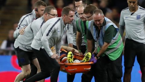 England's Luke Shaw is carried off the pitch on a stretcher after he injured himself during the UEFA Nations League soccer match between England and Spain at Wembley stadium in London, Saturday Sept. 8, 2018. (AP Photo/Frank Augstein)