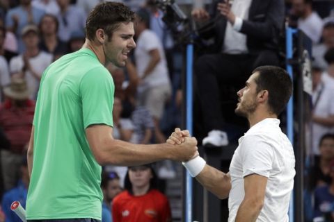 Italy's Thomas Fabbiano, right, is congratulated by United States' Reilly Opelka after winning their second round match at the Australian Open tennis championships in Melbourne, Australia, Wednesday, Jan. 16, 2019. (AP Photo/Aaron Favila)