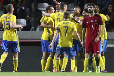 Sweden players celebrate their side's 3rd goal during the international friendly soccer match between Portugal and Sweden at the dos Barreiros stadium in Funchal, Madeira island, Portugal, Tuesday, March 28 2017. (AP Photo/Armando Franca)