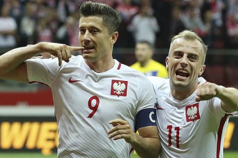 FILE - In this Monday, Sept. 4, 2017 filer, Poland's Robert Lewandowski,left, celebrates scoring their third goal from the penalty spot with Kamil Grosicki during the World Cup Group E qualifying soccer match between Poland and Kazakhstan at National stadium in Warsaw. (AP Photo/Czarek Sokolowski, File)