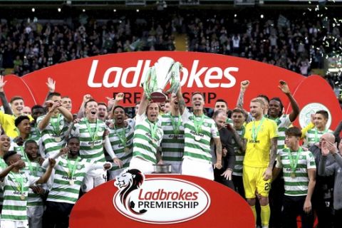 Celtic players celebrate with the trophy after winning the Scottish Premiership League soccer match at Celtic Park, Glasgow, Scotland, Sunday May 19, 2019. (Jane Barlow/PA via AP)