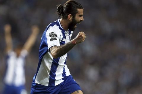 Porto's Sergio Oliveira celebrates after scoring the opening goal during the Portuguese league soccer match between FC Porto and Feirense at the Dragao stadium in Porto, Portugal, Sunday, May 6, 2018. Porto clinched the league title Saturday night, two rounds before the end, when Benfica and Sporting CP tied 0-0 in their Lisbon derby. (AP Photo/Luis Vieira)
