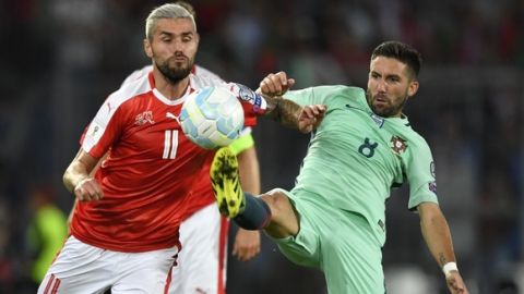 Portugal's midfielder Joao Moutinho (R) vies with Switzerland's midfielder Valon Behrami during the FIFA World Cup WC 2018 football qualifier between Switzerland and Portugal at the St. Jakob-Park stadium in Basel on September 6, 2016. / AFP / FABRICE COFFRINI        (Photo credit should read FABRICE COFFRINI/AFP/Getty Images)