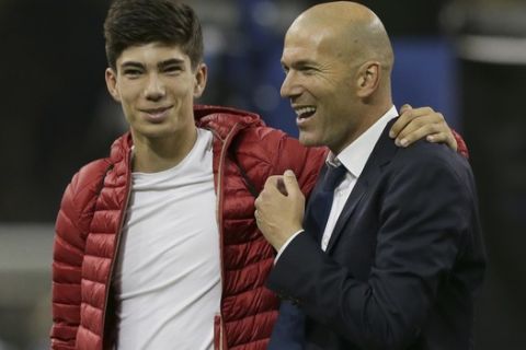 Real Madrid's head coach Zinedine Zidane is embraced by his son Luca at the end of the Champions League final soccer match between Juventus and Real Madrid at the Millennium Stadium in Cardiff, Wales, Saturday June 3, 2017. (AP Photo/Tim Ireland)