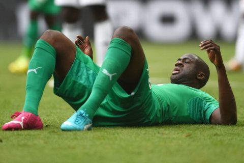 BRASILIA, BRAZIL - JUNE 19: Yaya Toure of the Ivory Coast lies injured during the 2014 FIFA World Cup Brazil Group C match between Colombia and Cote D'Ivoire at Estadio Nacional on June 19, 2014 in Brasilia, Brazil.  (Photo by Dennis Grombkowski - FIFA/FIFA via Getty Images)