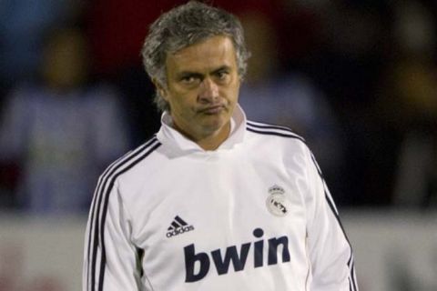 FILE - A Tuesday Dec. 13, 2011 photo from files showing Real Madrid's coach Jose Mourinho from Portugal as he walks near the touchline before the start of a Spanish Copa del Rey, round of 16, first leg soccer match against Ponferradina at the Toralin stadium in Ponferrada, Spain. Jose Mourinho is more concerned about hanging onto his current squad of players during the winter transfer window than signing new ones. Madrid's bench has meant players such as Kaka have not featured as expected, but the Spanish leader remains in the hunt for the league, Champions League and defending its Copa del Rey title, with a last 16 match against Malaga on Tuesday Jan 3, 2012.  (AP Photo/Lalo R. Villar, File)