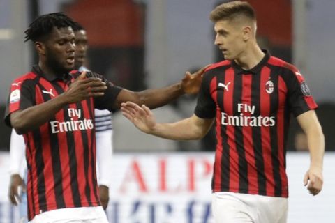 AC Milan's Franck Kessie, left, celebrates after scoring the opening goal with his teammate Krzysztof Piatek during the Serie A soccer match between AC Milan and Lazio, at the San Siro stadium in Milan, Italy, Saturday, April 13, 2019. (AP Photo/Luca Bruno)