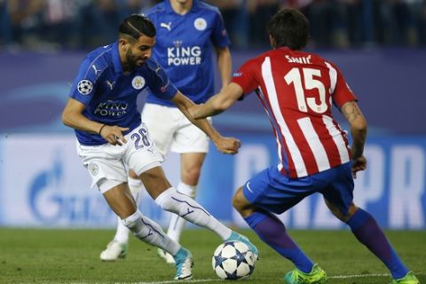Leicester City's Riyad Mahrez, left, attempts to take the ball past Atletico's Stefan Savic, right, during the Champions League quarterfinal first leg soccer match between Atletico Madrid and Leicester City at the Vicente Calderon stadium in Madrid, Spain, Wednesday, April 12, 2017. (AP Photo/Paul White)