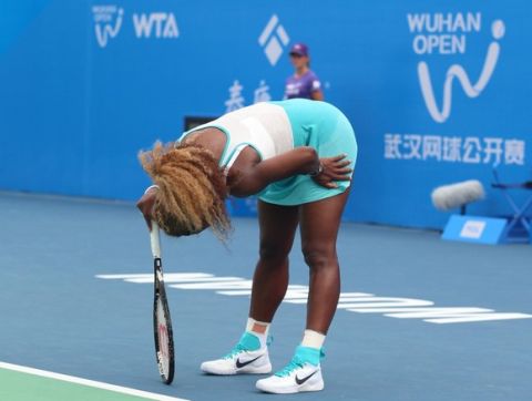 Serena Williams of the US reacts during her match against France's Alize Cornet at Wuhan Open tennis tournament in Wuhan, in China's Hubei province on September 23, 2014. Top seed Serena Williams had to be helped from the court as she retired ill during her first set at the inaugural Wuhan Open in China. CHINA OUT   AFP PHOTOSTR/AFP/Getty Images ORIG FILE ID: 533698576