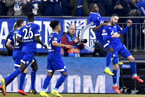 Schalke midfielder Nabil Bentaleb, right, celebrates with his teammates after scoring his side's second goal during the first leg, round of sixteen, Champions League soccer match between Schalke 04 and Manchester City at Veltins Arena in Gelsenkirchen, Germany, Wednesday Feb. 20, 2019. (AP Photo/Martin Meissner)