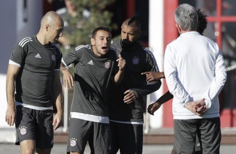 Bayern's Arjen Robben, from left, Rafinha and Arturo Vidal joke besides coach Jupp Heynckes at the last training session prior to the Champions League group B first leg soccer match between FC Bayern Munich and Celtic Glasgow, in Munich, Germany, Tuesday, Oct. 17, 2017. Munich will face Celtic on Wednesday. (AP Photo/Matthias Schrader)