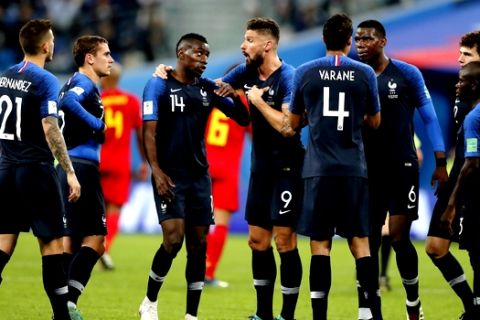 France's Olivier Giroud, center, argues to team mate Blaise Matuidi, 3rd left, during the semifinal match between France and Belgium at the 2018 soccer World Cup in the St. Petersburg Stadium in, St. Petersburg, Russia, Tuesday, July 10, 2018. (AP Photo/Frank Augstein)