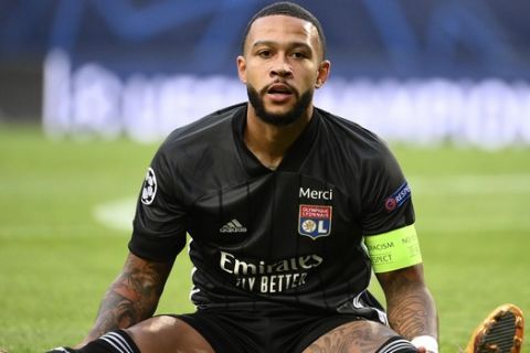 Lyon's Memphis Depay reacts after missing a chance to score during the Champions League semifinal soccer match between Lyon and Bayern at the Jose Alvalade stadium in Lisbon, Portugal, Wednesday, Aug. 19, 2020. (Franck Fife/Pool via AP)