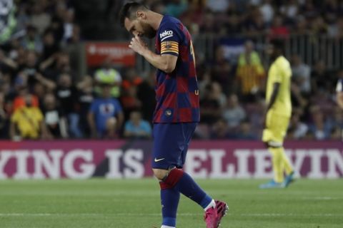 Barcelona's Lionel Messi walks off the pitch to get treatment after getting hurt during the Spanish La Liga soccer match between FC Barcelona and Villarreal CF at the Camp Nou stadium in Barcelona, Spain, Tuesday, Sep. 24, 2019. (AP Photo/Joan Monfort)