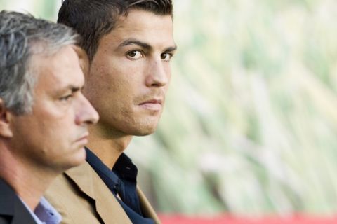 Real Madrid's head coach Jose Mourinho from Portugal, left, and Real Madrid player Cristiano Ronaldo from Portugal attend an award ceremony to the best soccer players of the Spanish League, in Madrid, Monday, Oct. 3, 2011. (AP Photo/Daniel Ochoa de Olza)