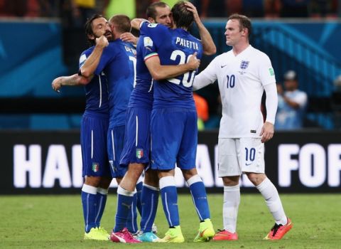 MANAUS, BRAZIL - JUNE 14:  Andrea Pirlo, Daniele De Rossi, Giorgio Chiellini and Gabriel Paletta of Italy celebrate defeating England 2-1 as Wayne Rooney of England looks on after the 2014 FIFA World Cup Brazil Group D match between England and Italy at Arena Amazonia on June 14, 2014 in Manaus, Brazil.  (Photo by Adam Pretty/Getty Images)