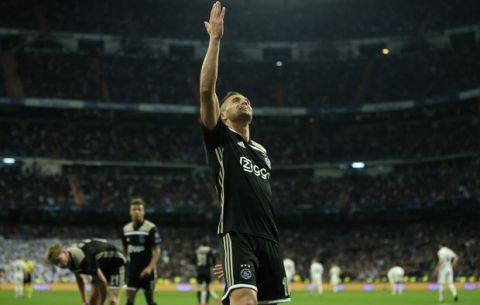 Ajax's Dusan Tadic celebrates after scoring his side's third goal during the Champions League round of 16 second leg soccer match between Real Madrid and Ajax at the Santiago Bernabeu stadium in Madrid, Tuesday, March 5, 2019. (AP Photo/Bernat Armangue)