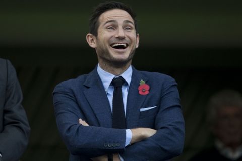 Former Chelsea player Frank Lampard reacts as fans notice him in the stands before the English Premier League soccer match between Chelsea and Liverpool at Stamford Bridge stadium in London, Saturday, Oct. 31, 2015.  (AP Photo/Matt Dunham)