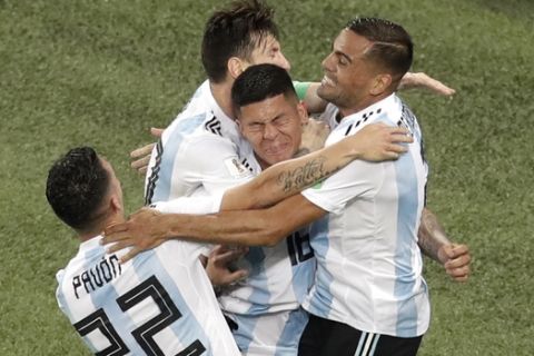 Argentina's Marcos Rojo, center, celebrates with teammate Lionel Messi after scoring his side's second goal during the group D match between Argentina and Nigeria, at the 2018 soccer World Cup in the St. Petersburg Stadium in St. Petersburg, Russia, Tuesday, June 26, 2018. (AP Photo/Michael Sohn)