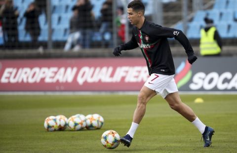Portugal's Cristiano Ronaldo controls the ball during a warm up prior to the start of the Euro 2020 group B qualifying soccer match between Luxembourg and Portugal at the Josy Barthel stadium in Luxembourg, Sunday, Nov. 17, 2019. (AP Photo/Francisco Seco)
