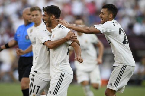 Real Madrid midfielder Marco Asensio, center, celebrates his goal with Lucas Vazquez (17) and Real Madrid midfielder Daniel Ceballos, right, during the second half at an International Champions Cup tournament soccer match against Juventus, Saturday, Aug. 4, 2018, in Landover, Md. Real Madrid won 3-1. (AP Photo/Nick Wass)