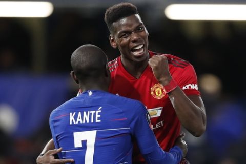 Manchester United's Paul Pogba, right, is hugs Chelsea's N'Golo Kante after the English FA Cup fifth round soccer match between Chelsea and Manchester United at Stamford Bridge stadium in London, Monday, Feb. 18, 2019. (AP Photo/Alastair Grant)