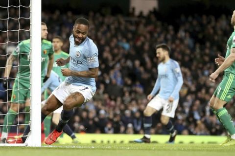 Manchester City's Raheem Sterling, center, celebrates scoring during the English Premier League soccer match between Manchester City and Watford at the Etihad Stadium, Manchester, England, Saturday March 9, 2019. (Martin Rickett/PA via AP)