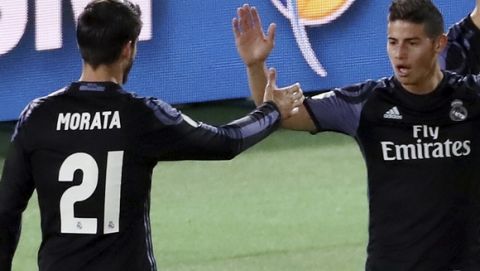 Real Madrid's Cristiano Ronaldo, second right, celebrates with teammates, Alvaro Morata, left, James Rodriguez and Nacho Fernandez, right, after scoring a goal during their semifinal match against Club America at the FIFA Club World Cup soccer tournament in Yokohama, near Tokyo, Thursday, Dec. 15, 2016. (AP Photo/Eugene Hoshiko)