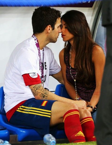 KIEV, UKRAINE - JULY 01:  Cesc Fabregas of Spain kisses his girlfriend Daniella Semaan on the substitutes bench following his team's victory in the UEFA EURO 2012 final match between Spain and Italy at the Olympic Stadium on July 1, 2012 in Kiev, Ukraine.  (Photo by Alex Grimm/Getty Images)