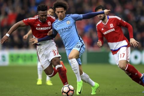 Manchester City's Leroy Sane, centre, and Middlesbrough's Adama Traore, left, in action during their English FA Cup quarter final soccer match at the Riverside Stadium in Middlesbrough, England, Saturday March 11, 2017. (Mike Egerton/PA via AP)