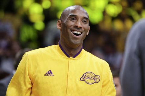 Los Angeles Lakers forward Kobe Bryant smiles to the crowd during a ceremony before Bryant's last NBA basketball game, against the Utah Jazz, Wednesday, April 13, 2016, in Los Angeles. (AP Photo/Jae C. Hong)
